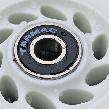 Close-up of a Tarmac skate wheel with a white rim and black center.