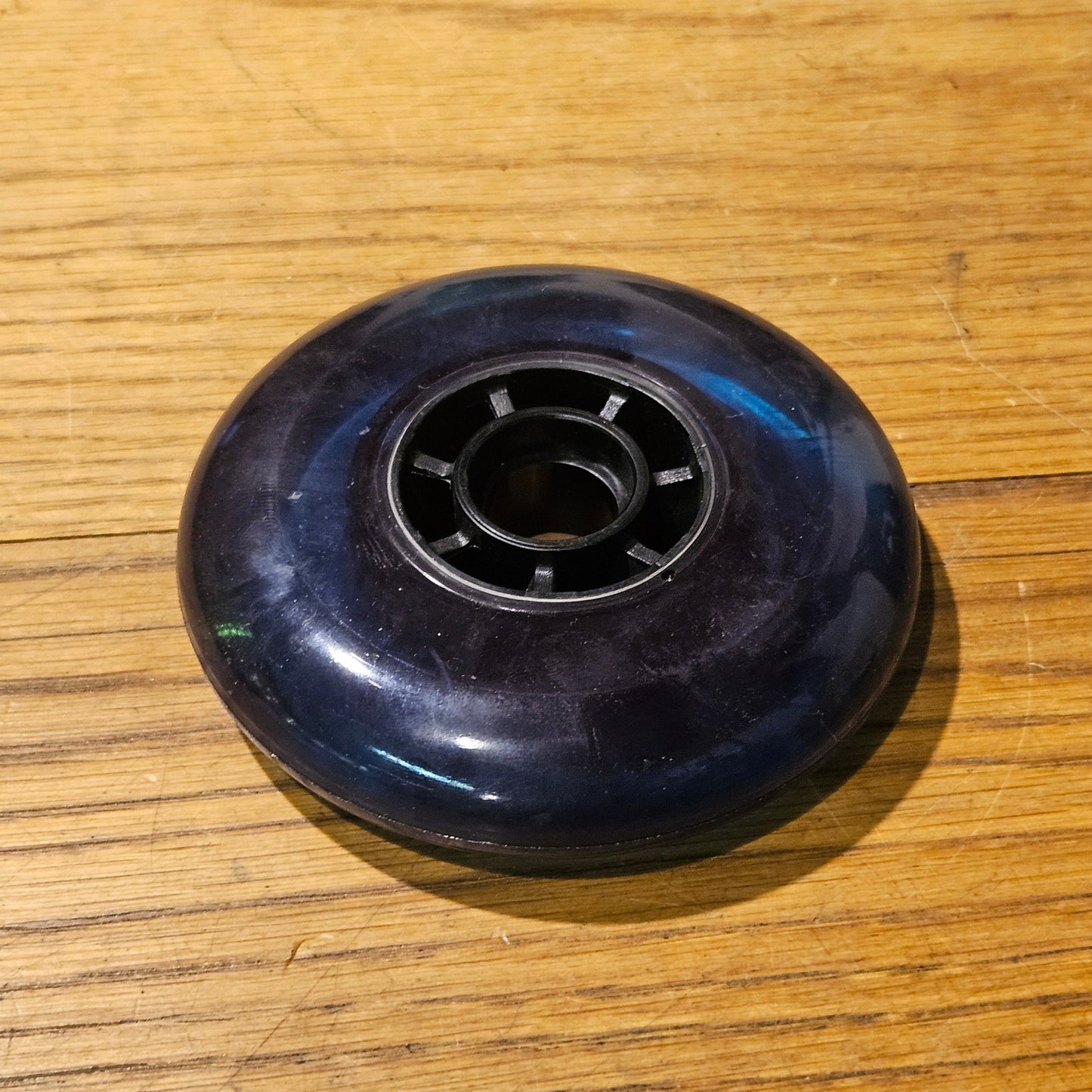 blue skate wheel on a wooden surface